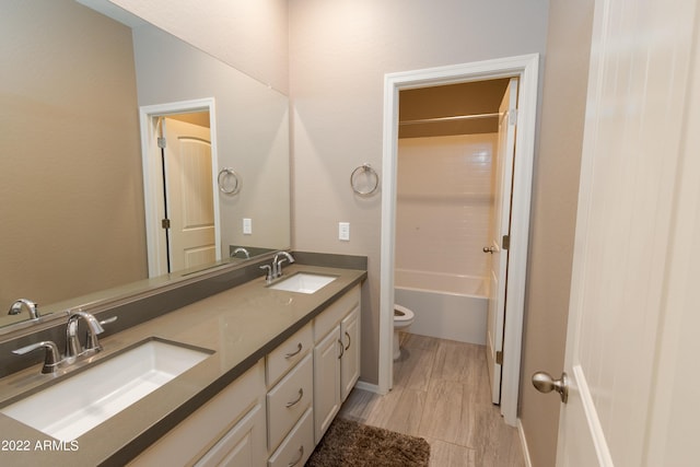 full bathroom with vanity, toilet, shower / bath combination, and wood-type flooring