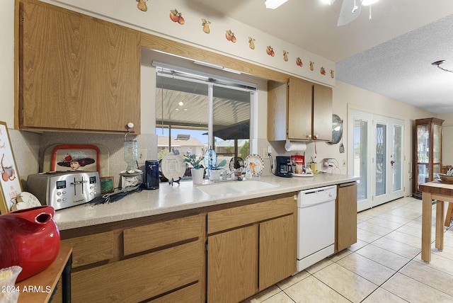 kitchen with french doors, light tile floors, sink, dishwasher, and ceiling fan