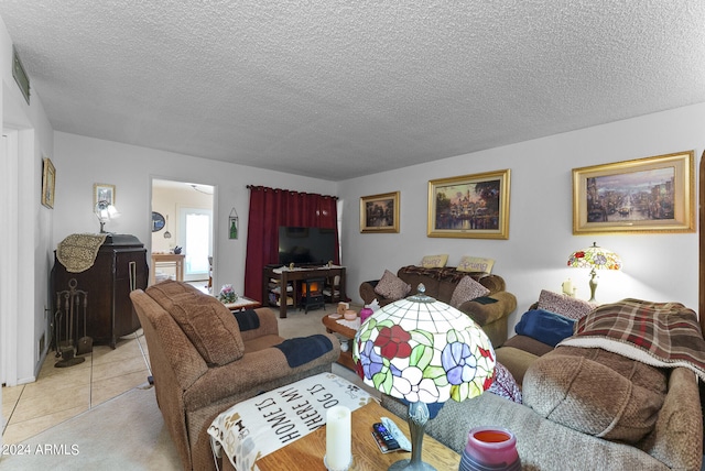 living room featuring light tile flooring and a textured ceiling