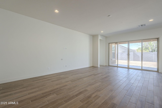 spare room with hardwood / wood-style floors