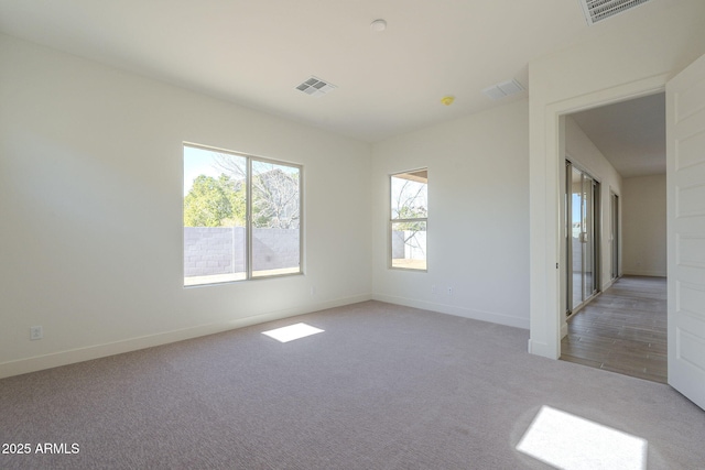 empty room featuring light colored carpet