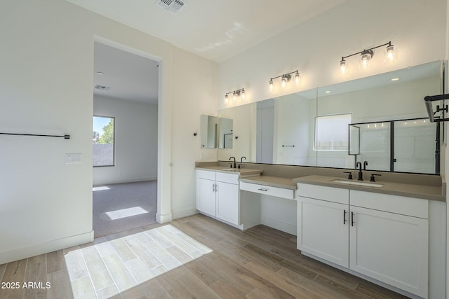 bathroom with vanity, hardwood / wood-style floors, and walk in shower