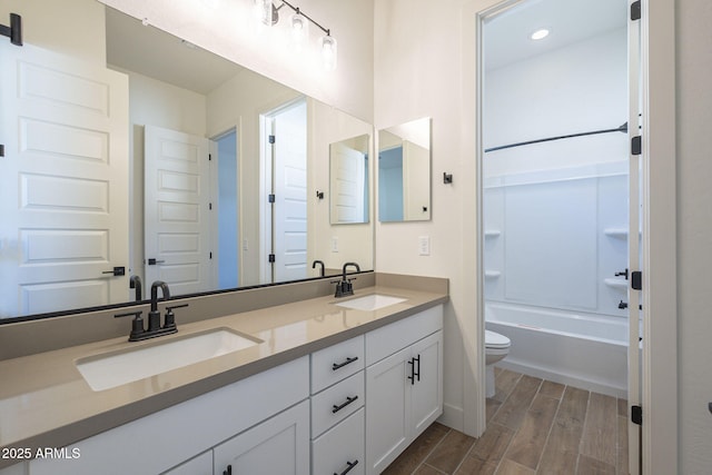 full bathroom with shower / bath combination, vanity, and toilet