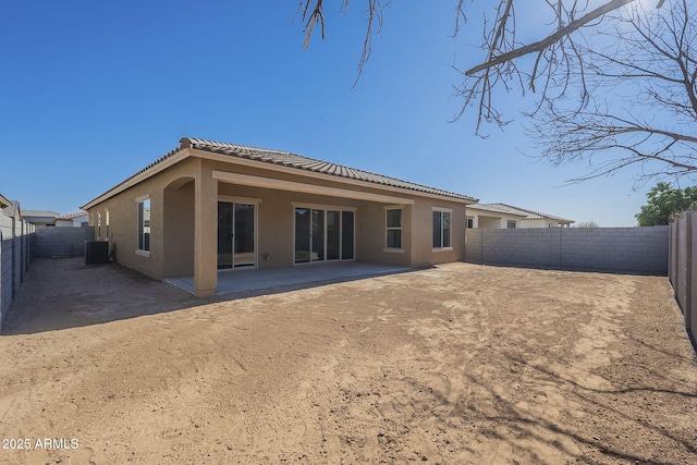 back of property featuring cooling unit and a patio area