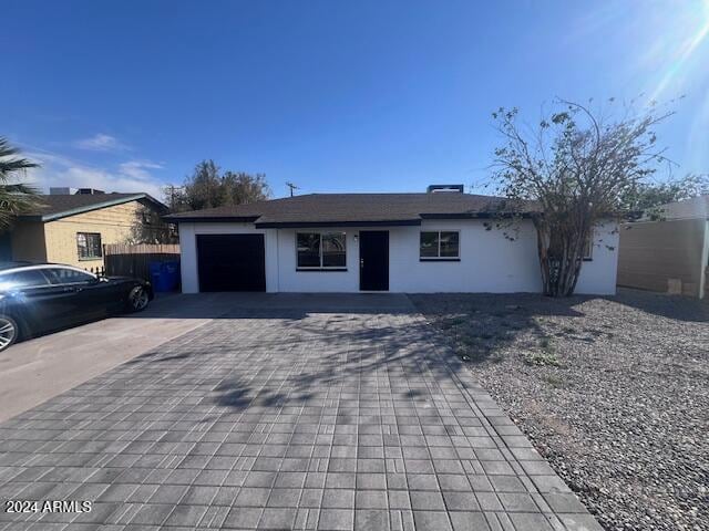 ranch-style house featuring a garage