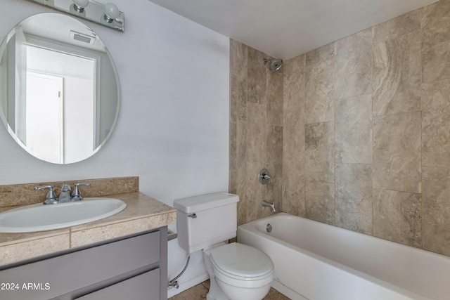 full bathroom featuring toilet, tiled shower / bath, and vanity