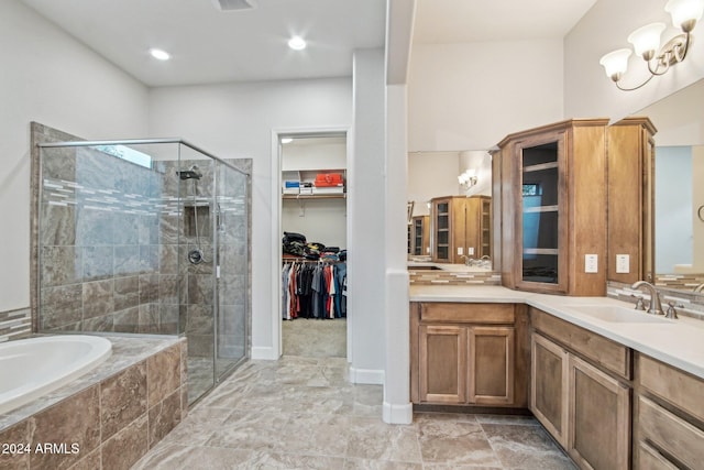 bathroom with vanity and independent shower and bath