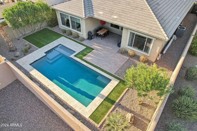 rear view of house with central air condition unit and a patio