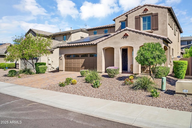 12932 W Cassia Trl, Peoria, AZ 85383 - mediterranean / spanish-style house with stucco siding, solar panels, a garage, and driveway