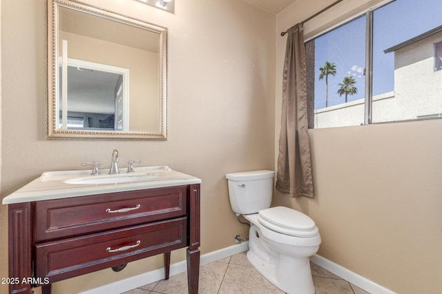 619 E Jensen St Unit 34, Mesa, AZ 85203 - bathroom featuring toilet, vanity, baseboards, and tile patterned flooring