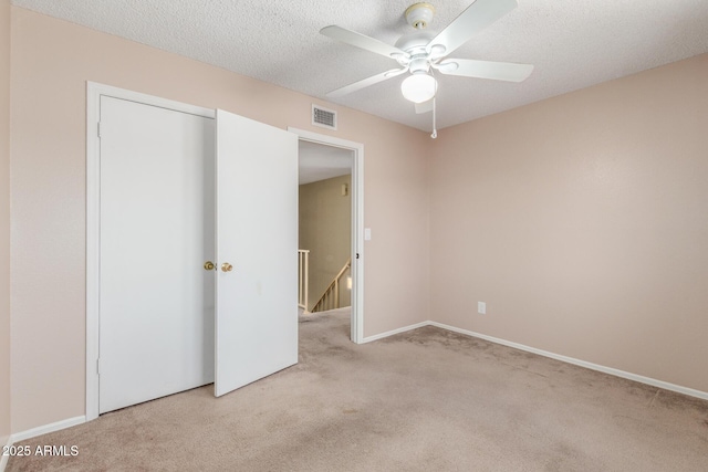 619 E Jensen St Unit 34, Mesa, AZ 85203 - unfurnished bedroom featuring carpet floors, baseboards, ceiling fan, a closet, and a textured ceiling