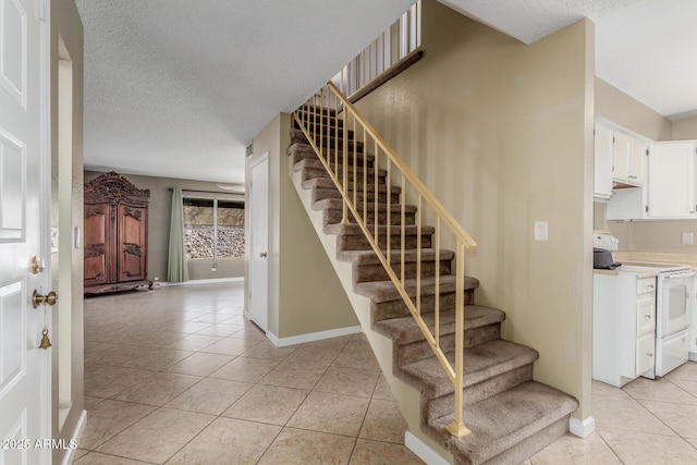 619 E Jensen St Unit 34, Mesa, AZ 85203 - staircase with tile patterned floors, baseboards, and a textured ceiling