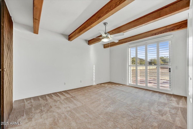 empty room with light carpet, ceiling fan, and beamed ceiling