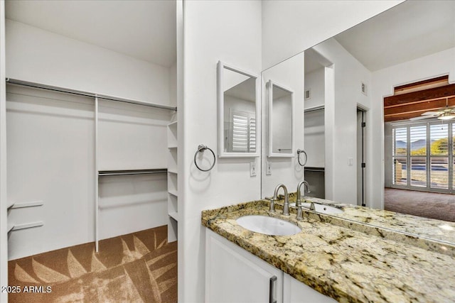 bathroom featuring vanity and ceiling fan