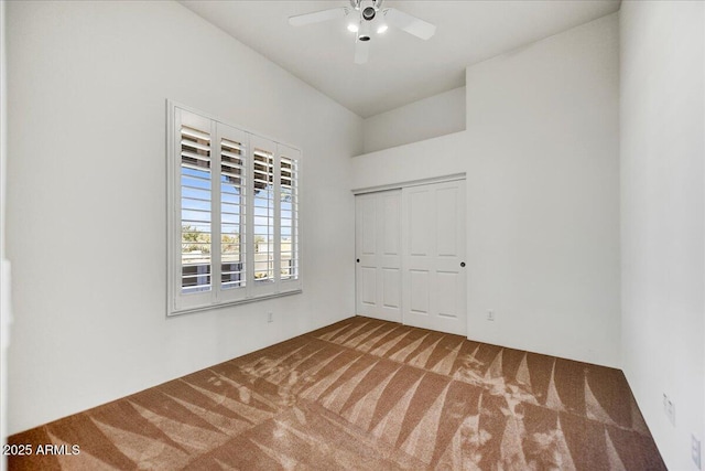 empty room featuring ceiling fan and carpet flooring