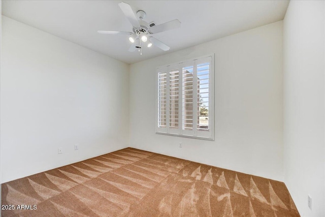 empty room with ceiling fan and carpet