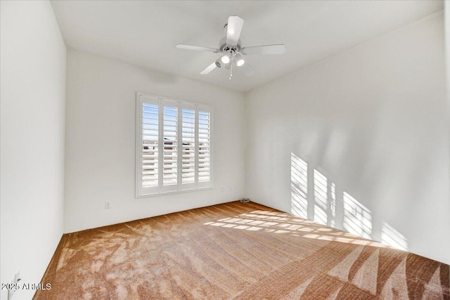 carpeted spare room with ceiling fan