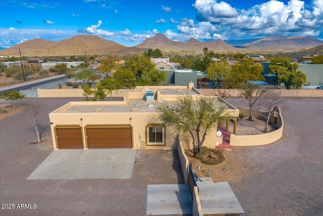 view of front facade featuring a garage and a mountain view