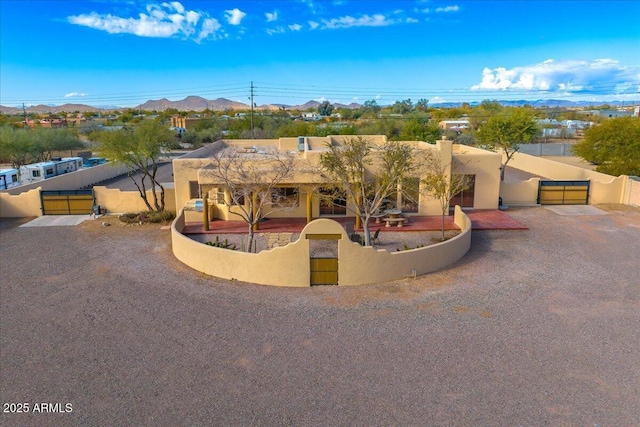 pueblo revival-style home featuring a mountain view