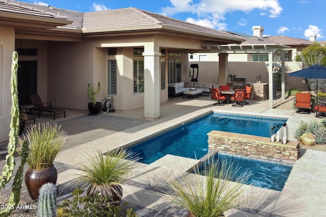 view of pool with an outdoor hangout area, a patio, and an outdoor kitchen