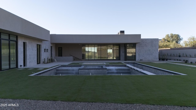 4644 E Indian Bend Rd, Paradise Valley, AZ 85253 - rear view of property featuring an in-ground hot tub, a chimney, and a lawn