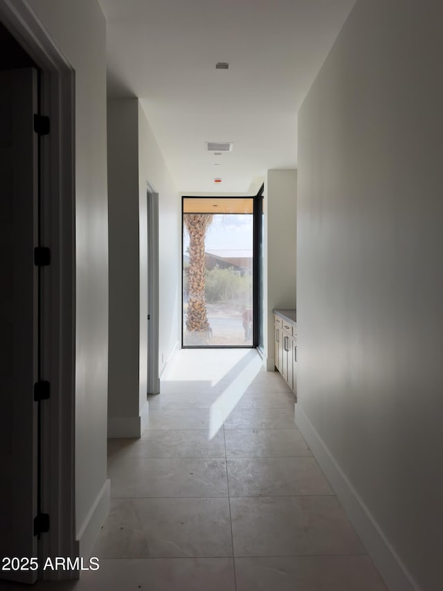 4644 E Indian Bend Rd, Paradise Valley, AZ 85253 - corridor with baseboards, concrete flooring, and a wall of windows