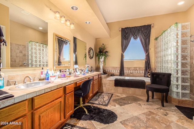 bathroom with dual bowl vanity, tile floors, and shower with separate bathtub