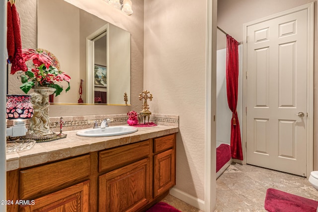 bathroom featuring vanity, toilet, and tile flooring