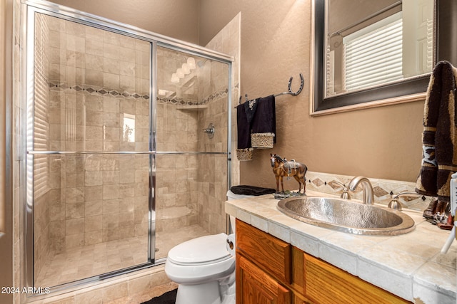 bathroom with an enclosed shower, toilet, and vanity