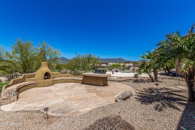 view of yard with a mountain view and a patio area