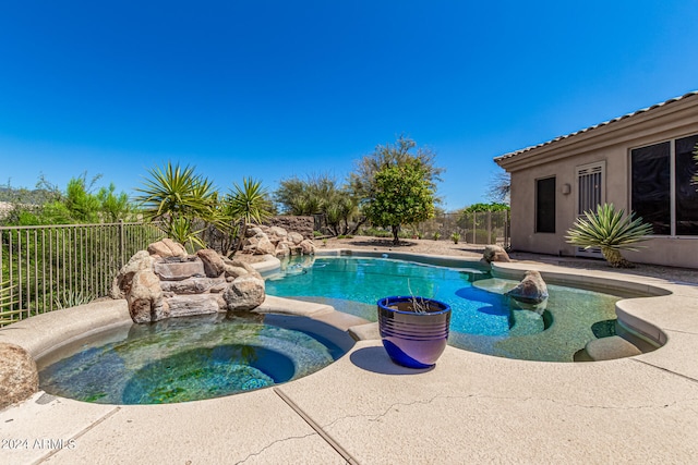 view of pool with an in ground hot tub