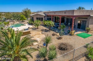 back of property featuring a fenced in pool and a patio area