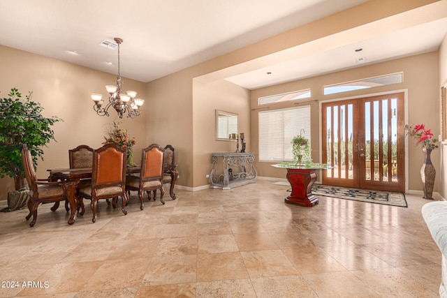 dining space with french doors, a notable chandelier, and light tile floors