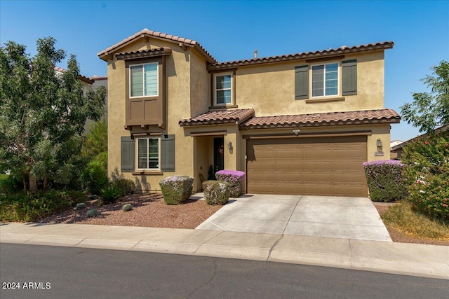 mediterranean / spanish house featuring a garage