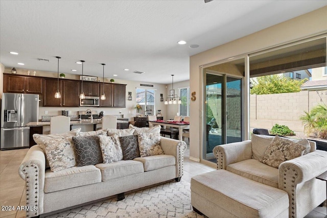 living room with a chandelier and light tile patterned floors