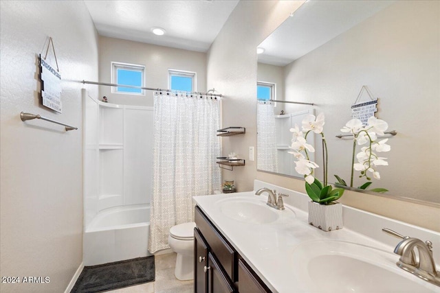 full bathroom with shower / bath combo with shower curtain, tile patterned floors, vanity, and toilet