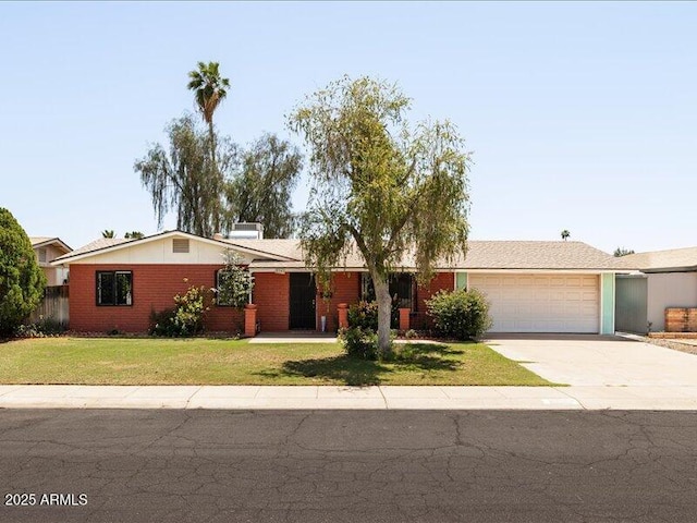 ranch-style home featuring a front lawn, driveway, and an attached garage