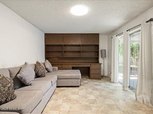 living area with a textured ceiling