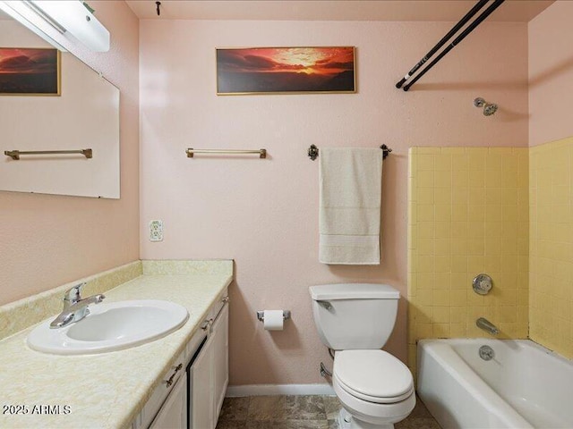 bathroom with toilet, baseboards, and vanity