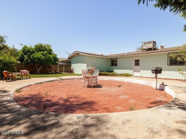 single story home with fence, a patio area, and central AC