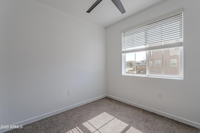 unfurnished room with light carpet, baseboards, and a ceiling fan