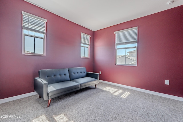 sitting room with carpet and baseboards