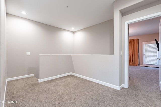 carpeted spare room featuring baseboards and recessed lighting