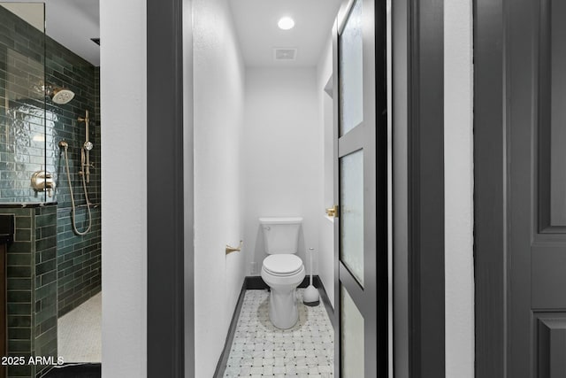 full bathroom featuring tile patterned flooring, toilet, visible vents, baseboards, and a tile shower