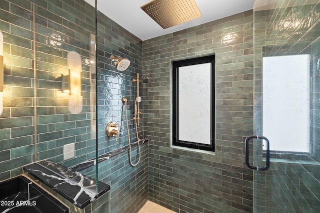 bathroom with a wealth of natural light and a tile shower