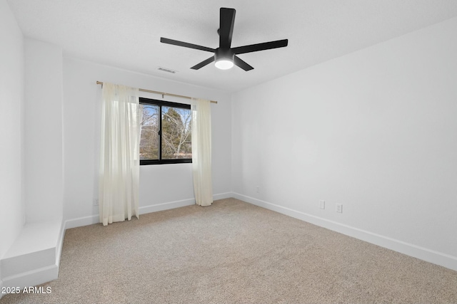 unfurnished room featuring ceiling fan, carpet floors, visible vents, and baseboards