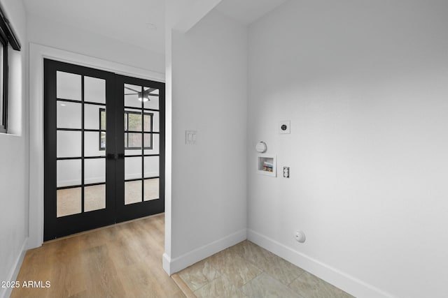 foyer with french doors and baseboards