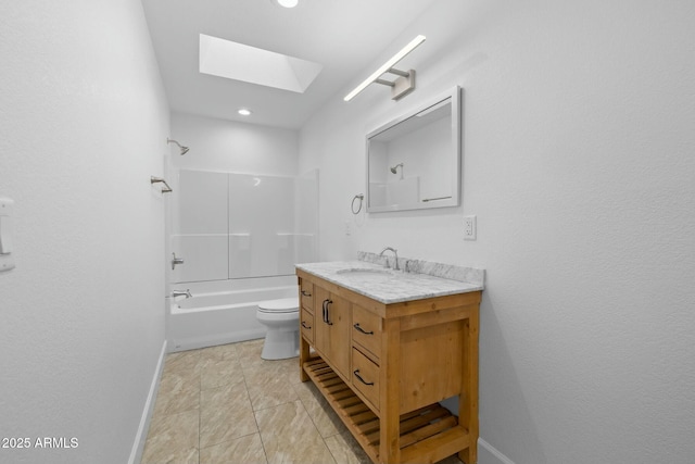 bathroom featuring shower / washtub combination, a skylight, vanity, and baseboards