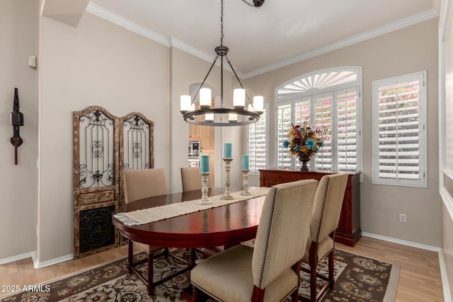 22232 N 48th St, Phoenix, AZ 85054 - dining room featuring baseboards, ornamental molding, light wood-style flooring, and a chandelier