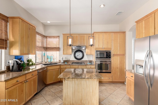22232 N 48th St, Phoenix, AZ 85054 - kitchen featuring a kitchen island, visible vents, appliances with stainless steel finishes, light brown cabinetry, and a sink